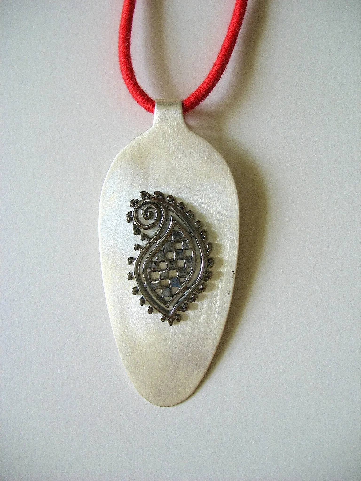 Stunning, super chic, long pendant with black rhodium plated paisley motif